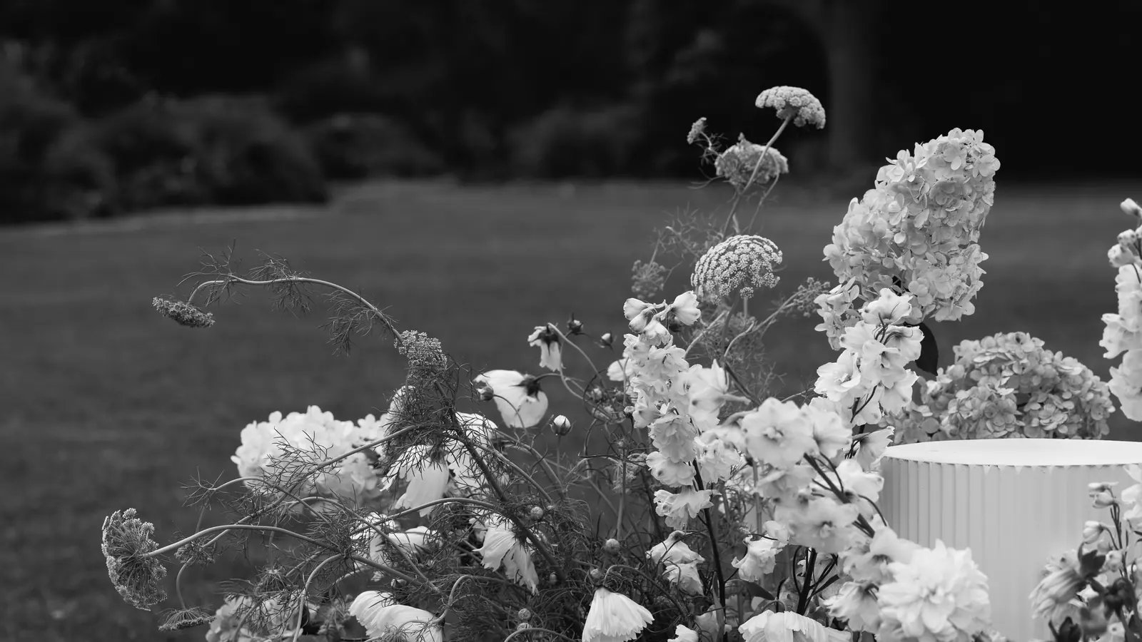 A couple at golden hour, bouquet in hand.