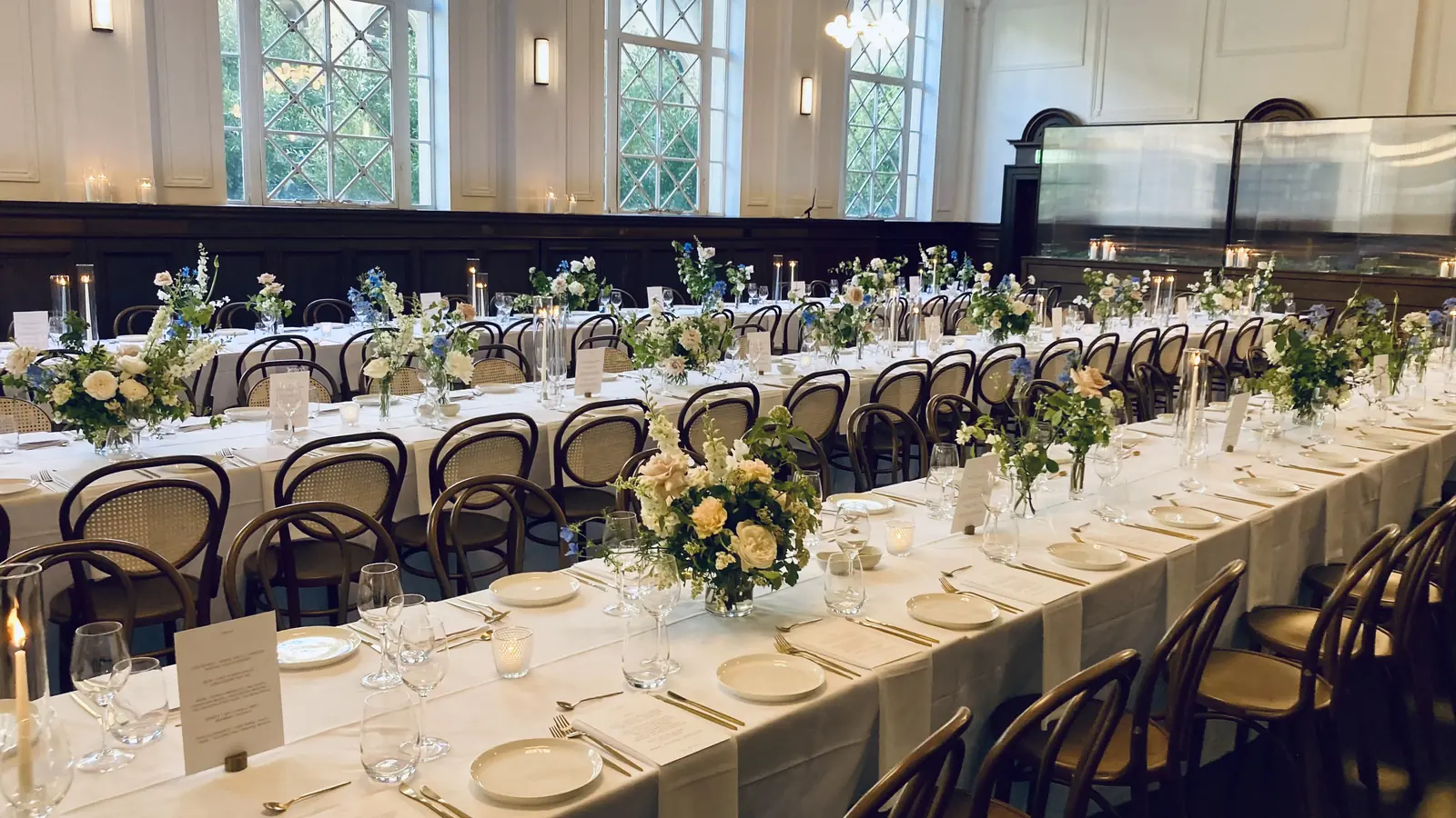 A long reception table, styled and set before guests arrive.