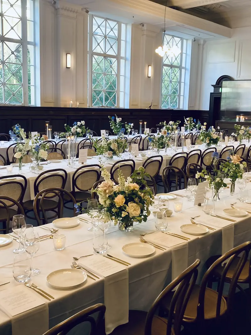 A long reception table, styled and set for dinner.
